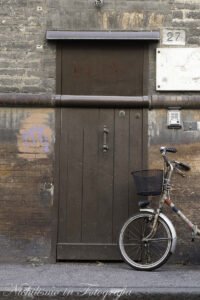 Door and bicycle in Ferrara, Italy