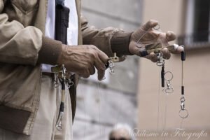 Puppet master with dog marionette in the square, Ferrara Italy